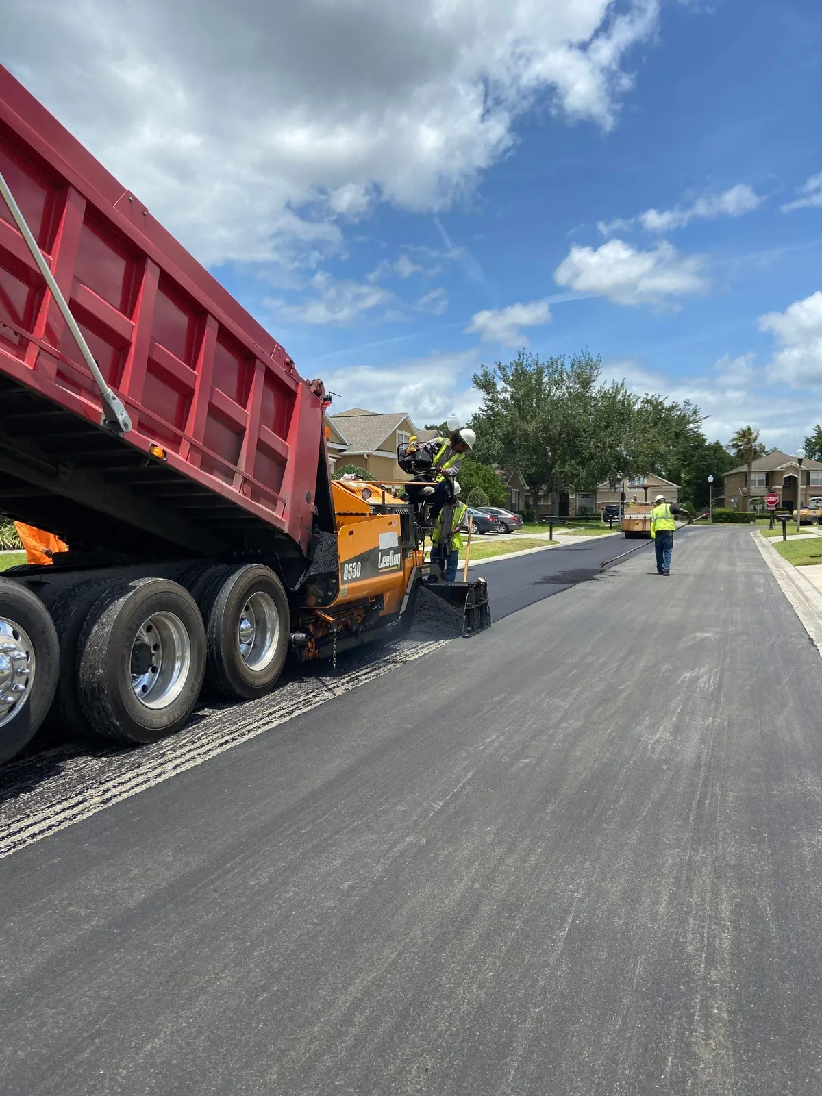 Active asphalt paving work in an Ormond Beach neighborhood
