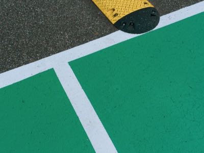 Yellow and black speed bump in a parking lot