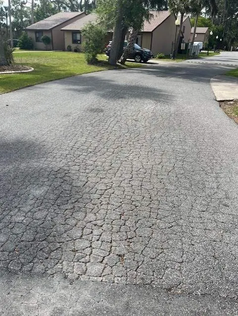 Alligator cracking pattern across an asphalt parking lot in Central Florida